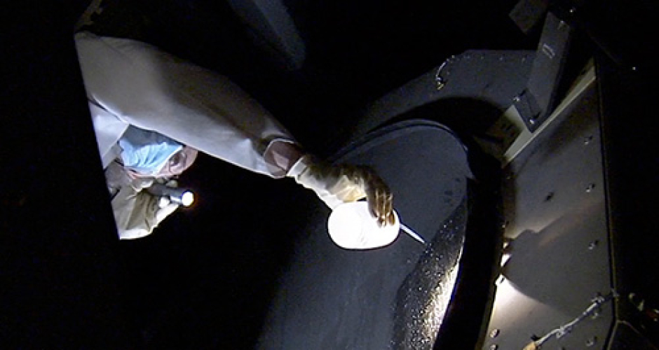 Technician washing mirror