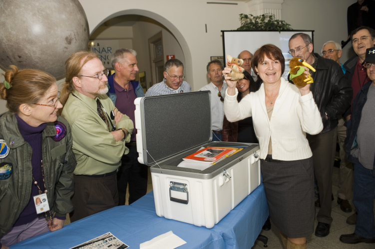 Former mission director Wendy Dolci holds up two mascots from the Kuiper Airborne Observatory during the KAO time capsule opening ceremony on Nov. 10, 2010.